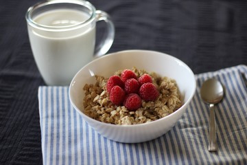 Porridge with raspberries, cup of milk (healthy breakfast)