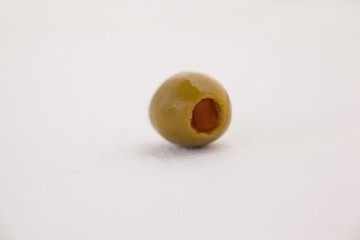 Single olive on table