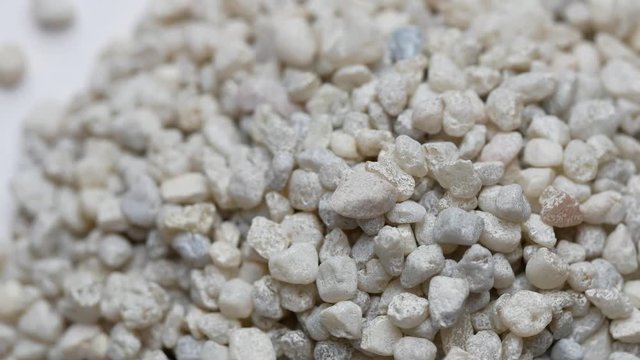 Zeolite natural raw stones rotating  on white background. Close up