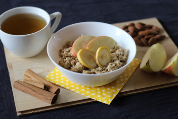 Porridge with apple, banana, almonds, cinnamon (healthy breakfast)