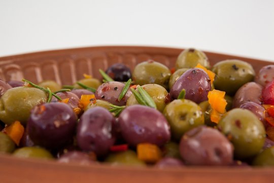 Close up of olives served with chili pepper