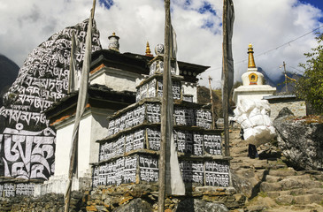 Buddhist Temple Stupa and Prayer Flags in Nepalese Village on Trekking Path from Lukla to Namche Bazaar in Nepal Himalaya Mountains