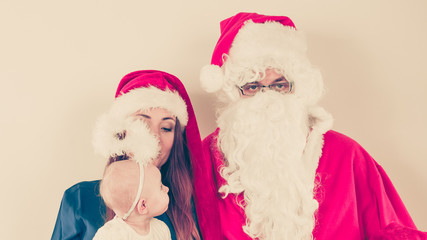 Santa Claus and woman with christmassy hat