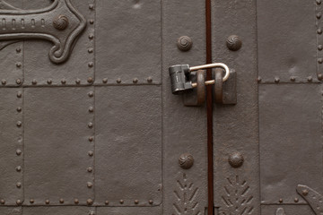 beautiful antique metal door with padlock, very sturdy and reliable