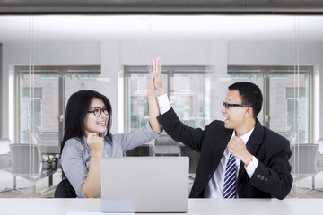 Business people giving a high five gesture