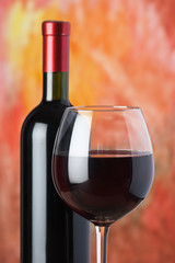 bottle and a wine glass with red wine