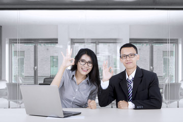 Asian business people showing OK sign