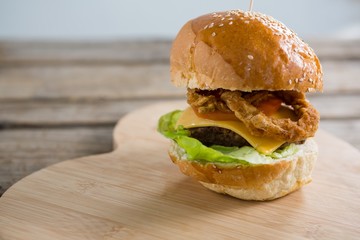 Close up of cheeseburger with onion rings