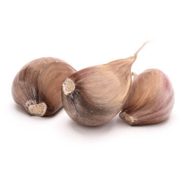 Three garlic cloves isolated on white background cutout