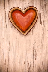 Fototapeta na wymiar One wooden heart on rustic wood background. Valentines days concept. Love symbol. Greeting card with copy space.