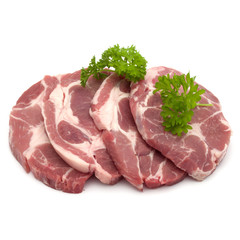 Raw pork neck chop meat with parsley herb leaves garnish isolated on white background cutout