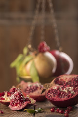 Obraz na płótnie Canvas Raw Red Pomegranate With Seeds On Table