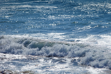 Fototapeta premium Wave of blue ocean on sandy beach. Background.