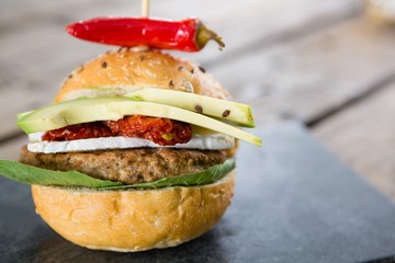 Close up burger with jalapeno pepper and vegetables