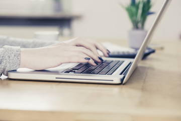 Young business woman, typing on notebook