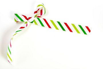 Hand tied silk striped holiday ribbon in white, green and red, isolated on white