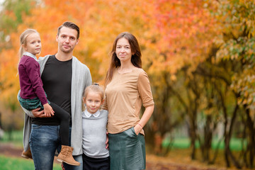 Portrait of happy family of four in autumn day