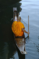monk on boat  collecting offering 