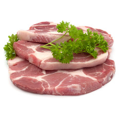 Raw pork neck chop meat with parsley herb leaves garnish isolated on white background cutout