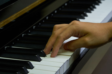 Fototapeta na wymiar Playing piano in studio with close up shot