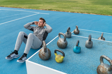 Fitness gym man training abs doing situps exercise crunches for weight loss and ab muscles toning....
