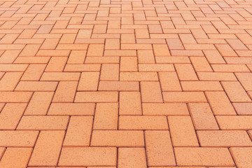 Paver brick floor also call brick paving, paving stone or block paving. Manufactured from concrete or stone for road, path, driveway and patio. Empty floor in perspective view for texture background.