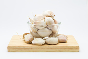 Garlic bulb on wooden board, on white background