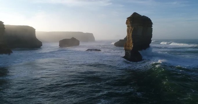Between rock formation apostles off australian coast on Great Ocean road low under stormy waves
