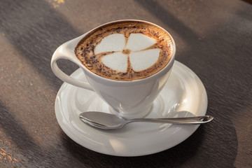 Cup of coffee art on old wooden table