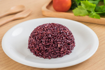 Black rice cooked on white plate