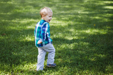 Little boy having fun playing in the Park on the grass