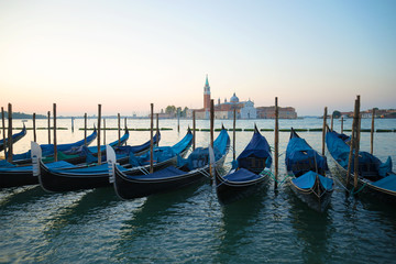 Venetian gondolas in the background of the Cathedral of San Giorgio Maggiore in the early morning. Venice, Italy