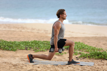 Lunge exercise fitness man training lunges exercising legs muscles with dumbbell weights. Male fitness model doing alternating lunge workout training glutes, hamstrings and quadriceps.