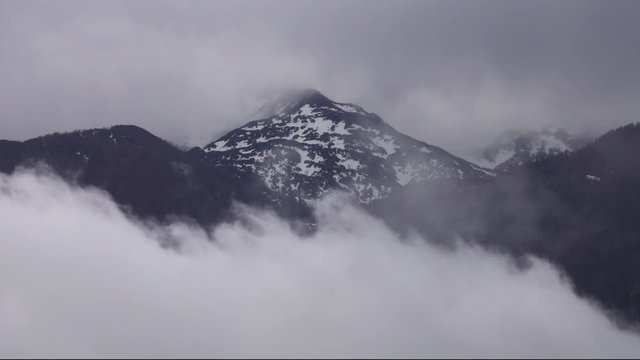 Top of mountain in snow and clouds landscape in alps, 4k
