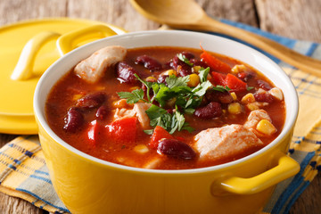 chicken with chili, beans, corn and tomatoes close-up in a bowl. horizontal