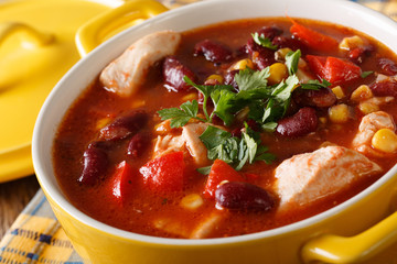 Traditional chicken chili stew with beans, corn and tomatoes close up. horizontal
