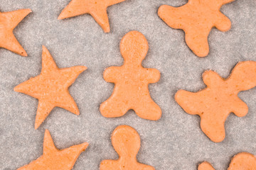 Christmas gingerbread cookies from fresh dough on baking paper: star, man