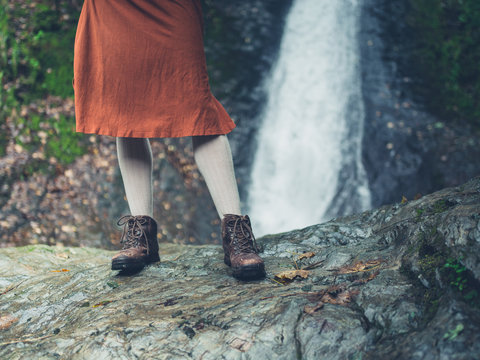 Feet and legs of woman by waterfall