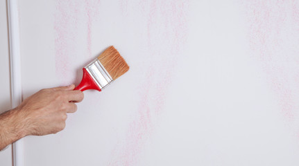 Painting the wall with a brush