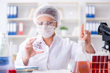 Female scientist researcher conducting an experiment in a labora