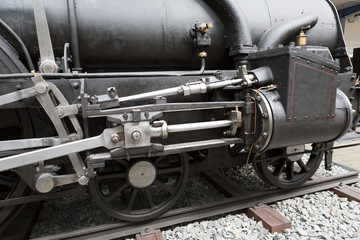 Fototapeta premium wheels of the old black locomotive close-up