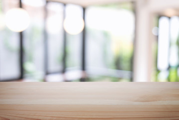 Empty wooden table and blur background of abstract in front of restaurant or coffee shop, cafe  can be used Mock up for display of product or for montage