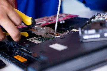 Naklejka premium Repairman working in technical support fixing computer laptop tr