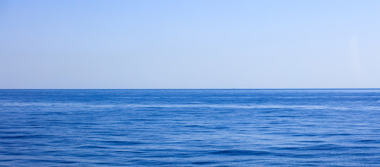 A view of calm sea and blue sky background,