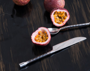 ripe passion fruit on black with...
