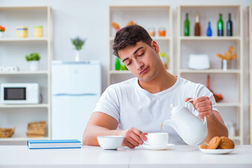 Man falling asleep during his breakfast after overtime work