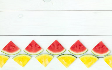 Red and yellow watermelon slices on sticks