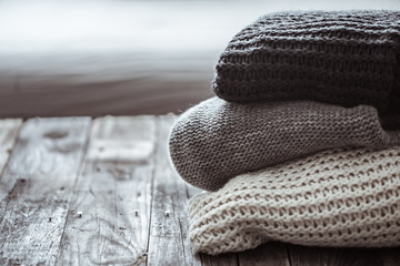 stack of cozy knitted sweaters