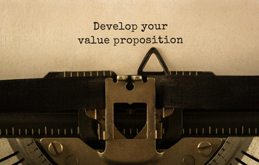 Text Develop your value proposition typed on retro typewriter