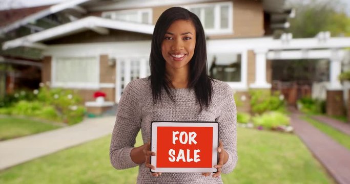 Portrait of cheerful black woman looking for buyer, advertising home for sale 